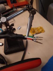 Photo of the pogo pins being soldered to wires